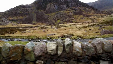 Video, Rugged Mountains with dry stone wall, as if from moving car L to R Stock Footage 204755456