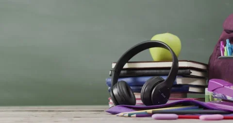 Video of school supplies and books on wooden table over blackboard Stock Footage 207067553