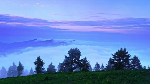 Video of sea of clouds on top of mountain in the morning and flowing thin fog Stock Footage