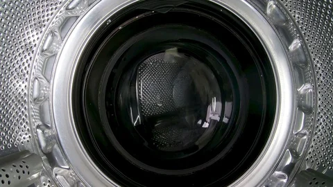 Video set Washing Machine. Smiling Young Man in Grey Jeans and Shirt Sits in Stock Footage 129473791
