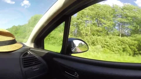 Video shooting in motion from the car window, view in the rear-view mirror Stock Footage 156702528