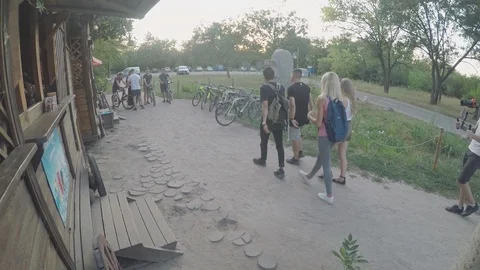 Video shooting process by a group of young people near the bike rental Stock Footage 111906694