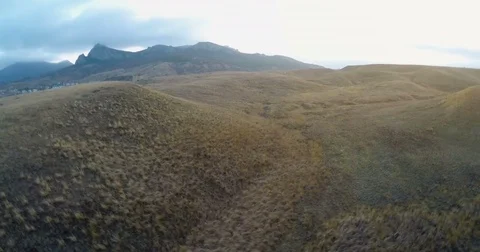 Video shooting of slopes of hills on a background of a mountain ridge Stock Footage 84553252