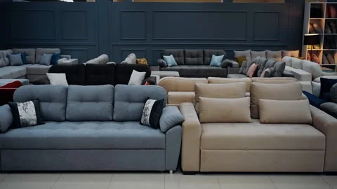 Video shot in a sofa store. A wide range of gray, brown, purple sofas. 4k videos Video stock 235057682