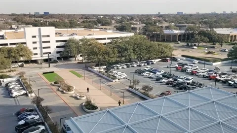This video show a busy parking lot at an office complex with cars driving Stock-Footage 299288564