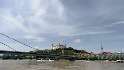 A video showcasing a serene riverside view with Bratislava Castle on a hill Video stock 302195046