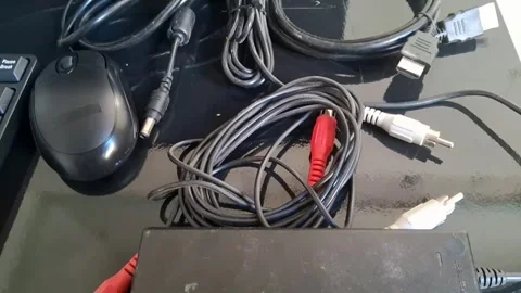 A video showcasing a tangled mess of cables and wires on a desk Stock Footage 340169376