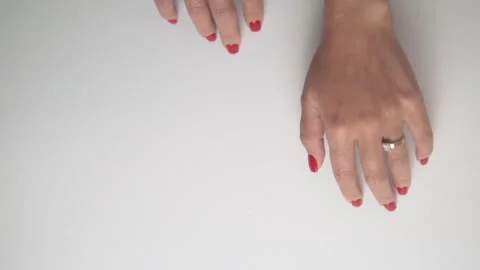Video shows closeups of a womans hands with red nails and rings Stock Footage 309625193