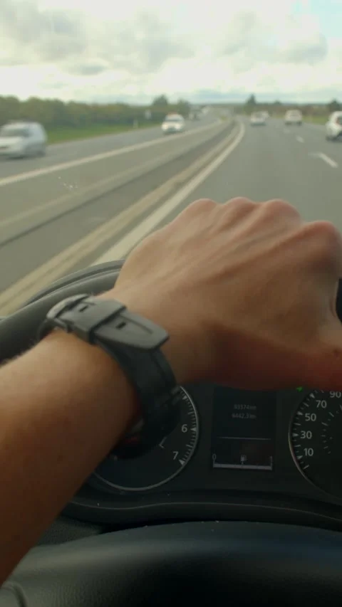 The video shows a driver on a highway, interacting with controls Stock Footage 317340261