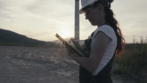 The video shows an engineer investigating the operation of a wind turbine Stock Footage 251441752
