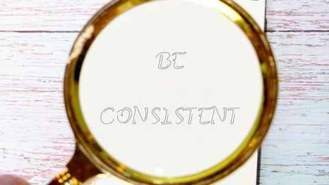 The video shows a hand using a magnifying glass to reveal the words. The focus Stock Footage 340873680