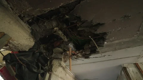 Video shows hole in ceiling from shell in Mariupol apartment. Damage reveals Stock Footage 281406926