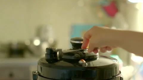This video shows how to use a pressure cooker in a kitchen Stock Footage 314338532
