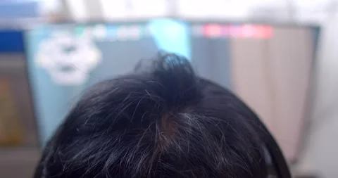 This video shows an individual deeply focused on a computer, immersed in technol Stock Footage 297200744