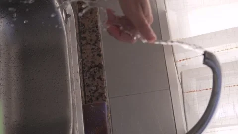 Video shows kitchen activities focused on the sink pouring, washing Stock Footage 295363202