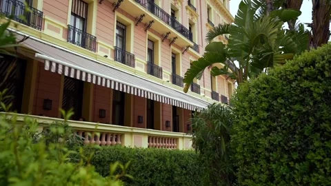 This video shows a large building with a striped awning and balconies Stock Footage 301282915