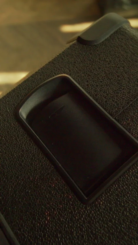A video shows a mysterious black object on a table, possibly a smartphone Stock Footage 319600059