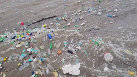 A video shows piles of plastic bottles, debris, and garbage floating on sea.. Stock Footage 328470370