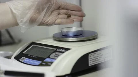 A video shows precise weighing of objects on a scale Stock Photos