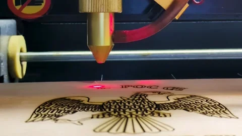 The video shows the process of laser engraving on wood. Stock Footage 306667995