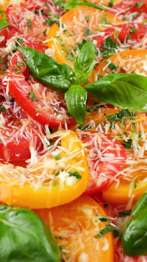 This video shows sliced red and yellow tomatoes on a rotating plate.  Stock-Footage 341486887
