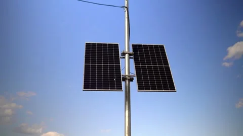 This video shows solar panels installed on a pole in the city to power Stock Footage 240579936