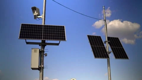 This video shows solar panels installed on a pole in the city to power Stock Footage 240580450