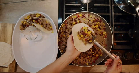 A video shows someone making vibrant and delicious tacos in a kitchen Stock Footage 307937455