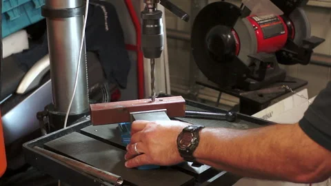 This video shows someone operating a drill press Stock Footage 274920777