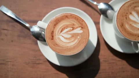 The video shows two white cups of coffee inside mounted on saucers. Video stock 234020127