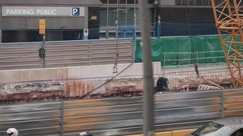 Video shows urban development with a construction site and traffic Stock Footage 295419470