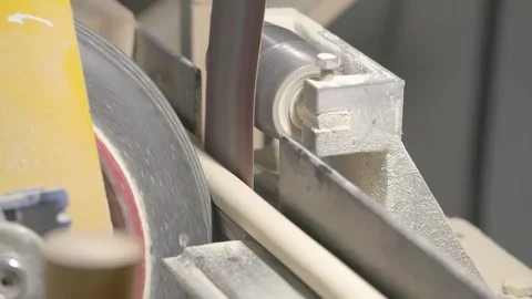 The video shows a woodworking process, where a spinning machine smooths Stock Footage 296247807