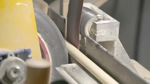 The video shows a woodworking process, where a spinning machine smooths wooden 스톡 동영상 296682287