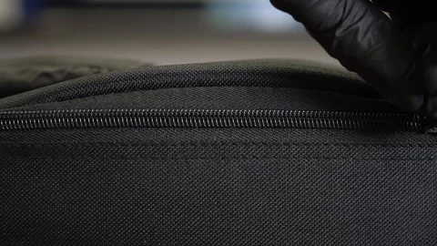 Video shows zipper closure. Lock clasp. A gloved hand closes the zipper. Extreme Video stock 127595566
