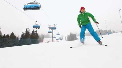 Video of skier going downhill under cable road and falling knocking over camera Stock Footage 140687076