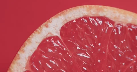 Video of sliced red grapefruit with copy space over red background Stock Footage 331447678