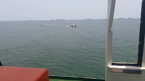 Video of a small pilot boat approaching a large passenger ship in the middle of  Stock Footage 324351775
