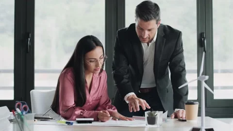 Video of smart architects working with plans while talking of their new des.. Stock Footage 227886663