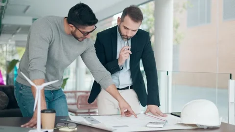 Video of smart architects working with plans while talking of their new des.. Stock Footage 247119821