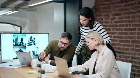 Video of smart group of architects working with laptops and blueprints whil.. Stock Footage 240082561