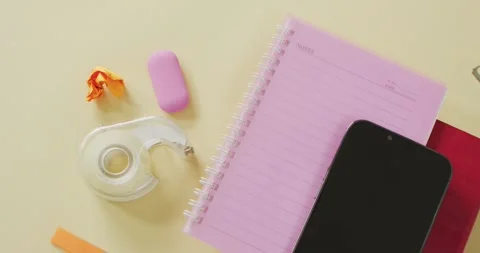 Video of smartphone with copy space, notebooks and school equipment on yellow Stock Footage 331306753