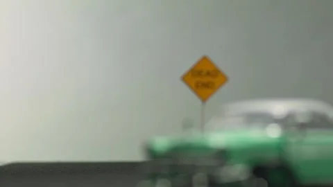 Video of a smashed, abandoned, light blue car figurine left in the middle of  Video stock 133491625
