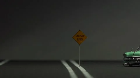 Video of a smashed, abandoned, light blue, retro car figurine left in the mid Stock Footage 133492269