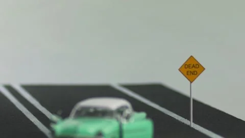 Video of a smashed, destroyed, abandoned, light blue, car figurine left in th Stock Footage 133491135