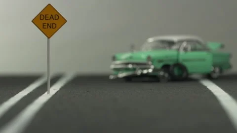 Video of a smashed, light blue car figurine left in the middle of a highway m Stock Footage 133491709