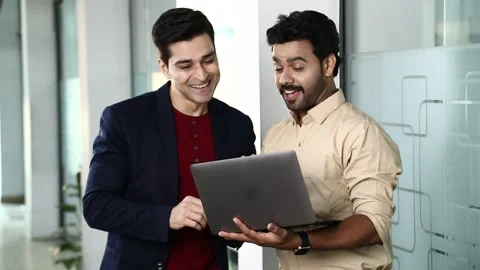Video of Smiling Employees using laptop and communicating together Stock Footage 244124481