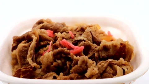 A video of someone putting pickled ginger on beef bowl. Stock Footage 335428641
