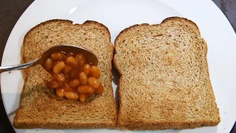 Video of spoon filled with baked beans and adding beans on toast. Stock Footage 118154862
