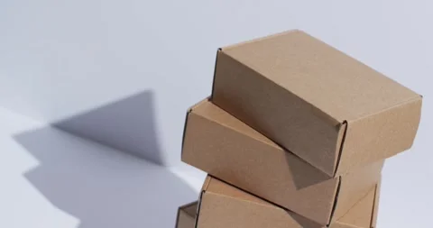 Video of stacked cardboard boxes with copy space over white background Stock Footage 250508701