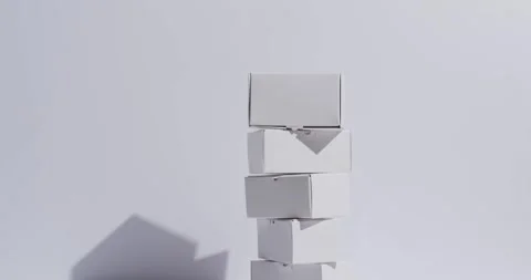 Video of stacked cardboard boxes with copy space over white background Stock Footage 250508702